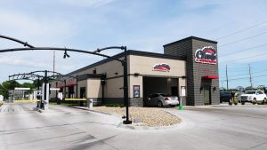 ground view of location with club car wash logo on building tower to the right and entry lanes on the left of screen