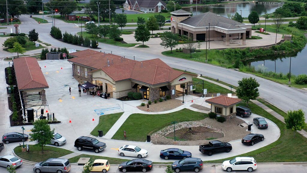 aerial view of location with lake on the right and parking lot with vacuums on the left