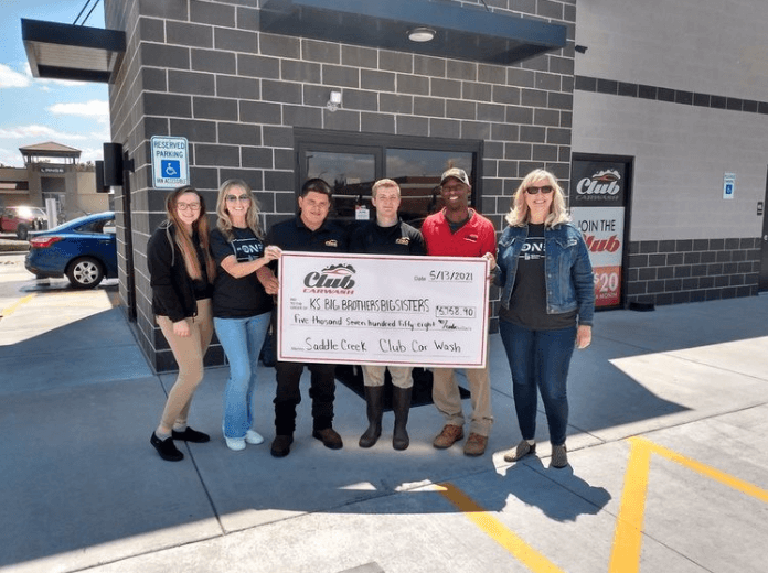 s broadway wichita kansas check presentation in front of building